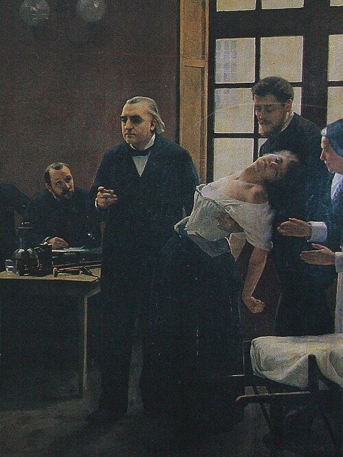 Enseignement de Charcot à la Salpêtrière : le professeur montrant à ses élèves (dont Joseph Babinski à droite sur le tableau) sa plus fidèle patiente, « Blanche » (Marie) Wittman, en crise d'hystérie. Détail du tableau d'André Brouillet : Une leçon clinique à la Salpêtrière, 1887).